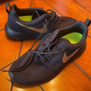 Black Nike with gold swoosh. Size 6